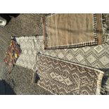 Four loose knotted rugs including a North African