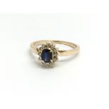 An 18ct yellow gold sapphire and diamond cluster r
