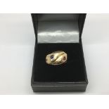 An antique gold snake ring set with a single ruby