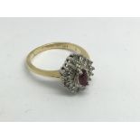 An 18ct gold diamind and ruby cluster ring, approx