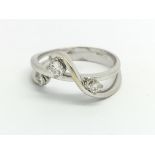 An 18ct white gold and diamond fancy three stone d