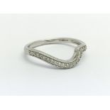 A 9ct white gold and diamond half eternity ring in