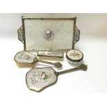 A gilt dressing table set with embroidered floral