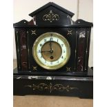 A collection of three slate mantle clocks .