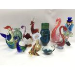 A collection of Murano glass items including a clo