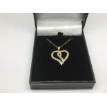 A 9ct gold diamond set heart shaped pendant on a 9