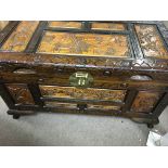 A carved camphor wood chest .