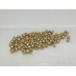 A collection of high carat gold beads, approx 3.4g