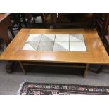 A modern coffee table with inset tiles to the top,