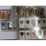 A collection of cigarette cards including Players,