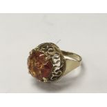 A gold ring stamped 585 inset with an amber stone