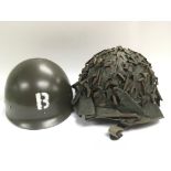 A vintage camouflage helmet stamped JAPY 1953 to t