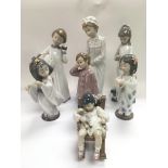 A collection of Lladro and Nao figures of children