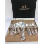 A collection of boxed and loose cutlery.