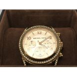 A boxed Michael Kors gold tone watch with rose col