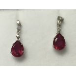 A pair of platinum ruby and diamond earrings with