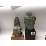Two carved stone Buddha possible Tibetan heads on