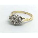 An 18ct yellow gold and diamond cluster ring, appr