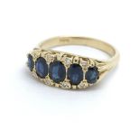 An 18ct yellow gold sapphire and diamond ring, siz