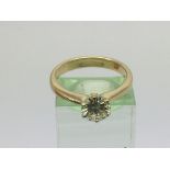 An 18ct gold solitaire diamond ring set with a rou