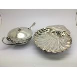 A silver mustard pot and spoon plus a silver dish