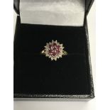 A 9 ct gold ring set with rubies and diamonds.