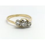 An 18ct yellow gold and three stone diamond ring,