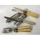 A set of six knives and forks and a set of six kni