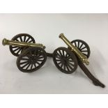 A pair of small brass and iron cannons