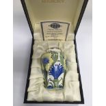 A small boxed limited edition Moorcroft enamel vas
