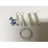 Three pairs of modern design silver earrings and t