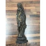 A cast bronze figure of a woman In classical roman