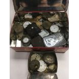 A tin of oddments including pocket watches and lig
