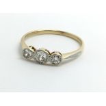 An 18ct yellow gold ring set with three diamonds,