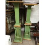 Two green painted pedestals .