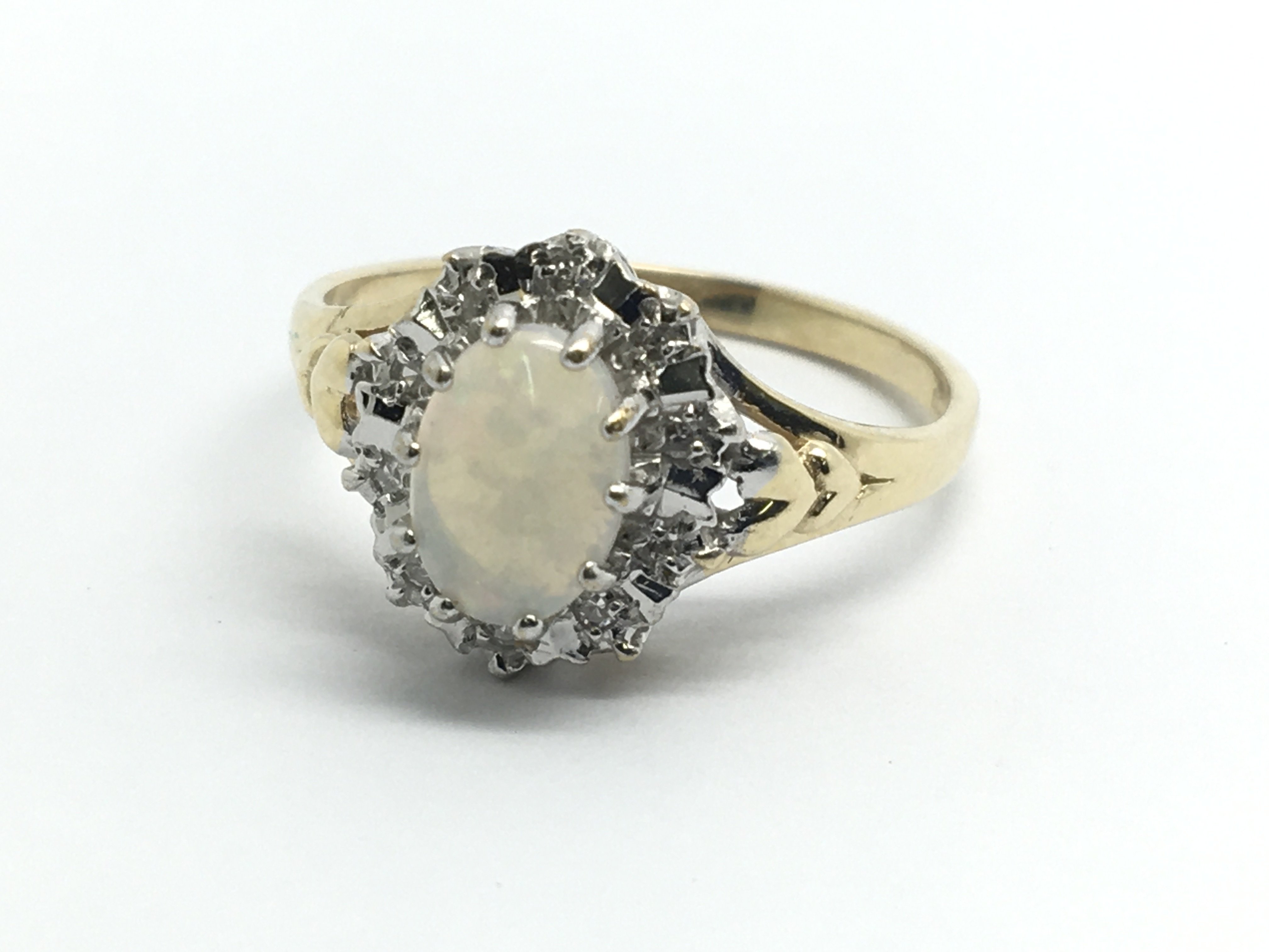 A 9ct yellow gold opal and diamond cluster ring, a