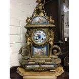 A gilt mantel clock the top surmount with cherub i