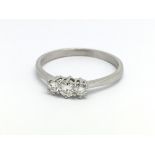 A platinum and three stone diamond ring, approx 0.