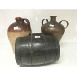 An oak metal bound barrel a stoneware flagon and a