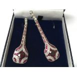 A pair of platinum Art Deco style ruby and diamond