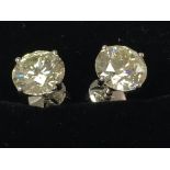 A pair of large white gold solitaire diamond studs