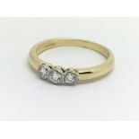 An 18ct yellow gold three stone diamond ring, appr