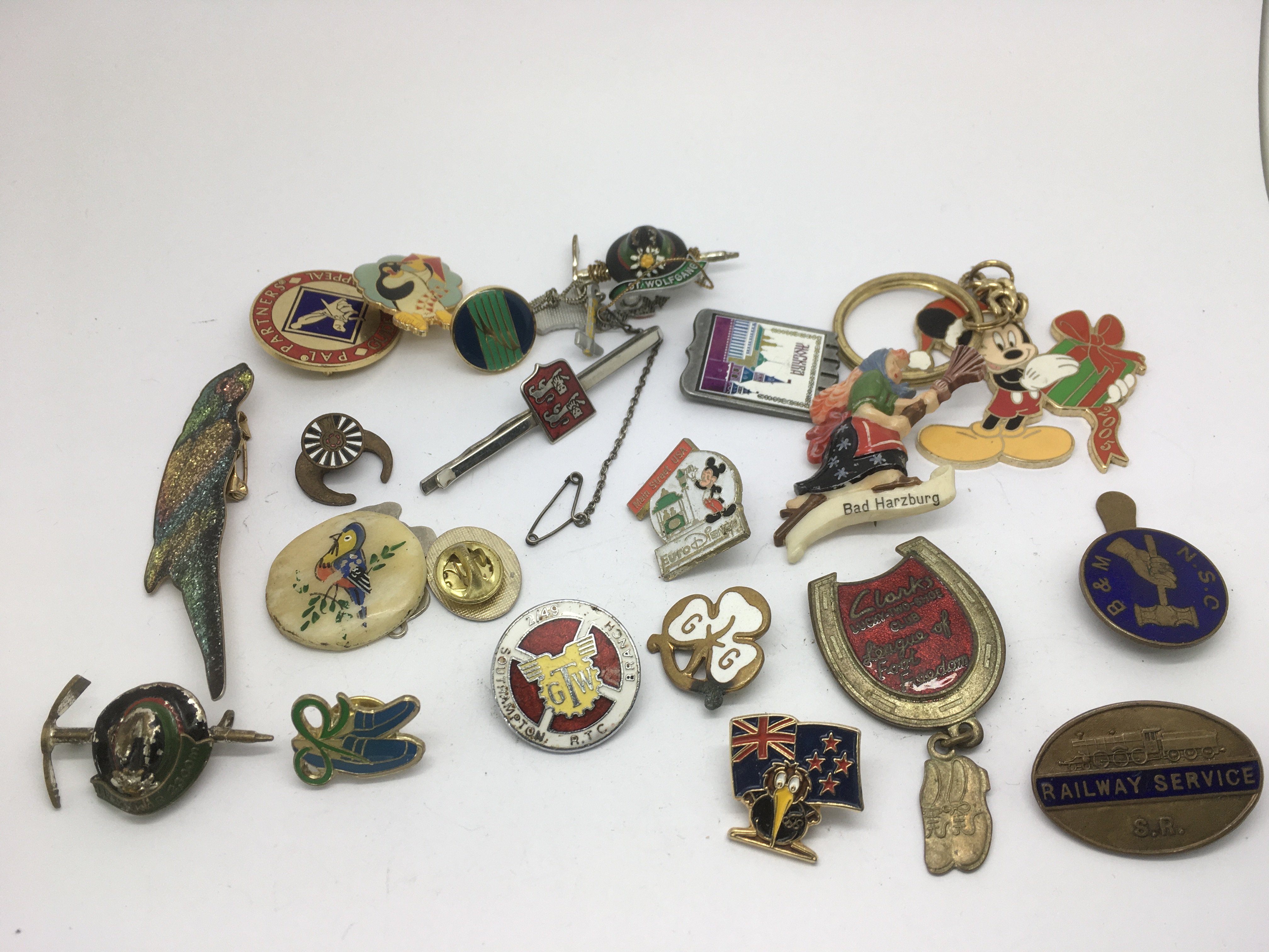 A collection of 20 plus enamel badges and brooches