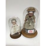 Two small dolls under domes 17 cm and 10 cm