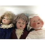 A bisque head doll and two others .