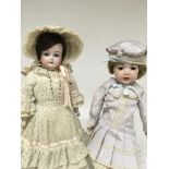 Two bisque head dolls in Edwardian style dress 38