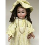 A German doll in Edwardian style dress on stand 50