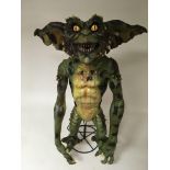 A large foam model Gremlin on stand appox height 8