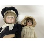 Two bisque headed dolls fitted in Edwardian style dress