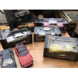 A collection of boxed 1:18 scale diecast vehicles